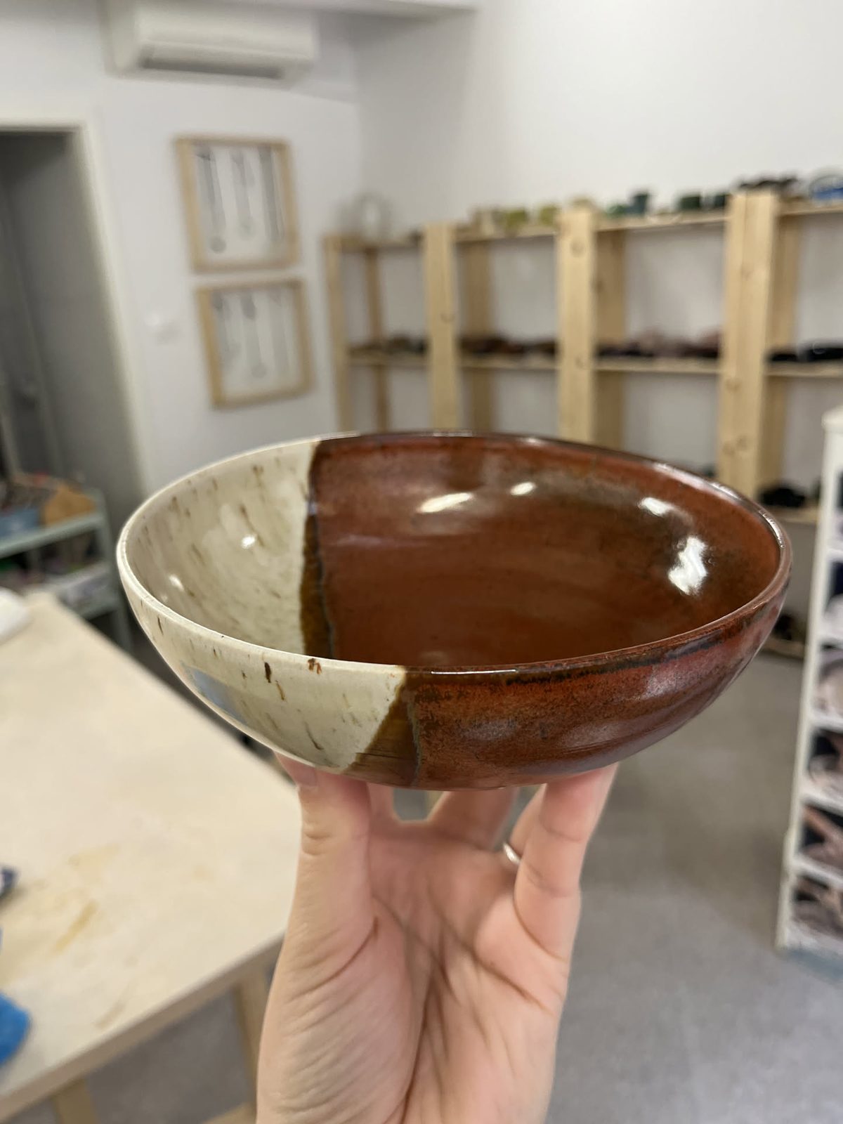 Small bowl glazed half rust red and half speckled cream