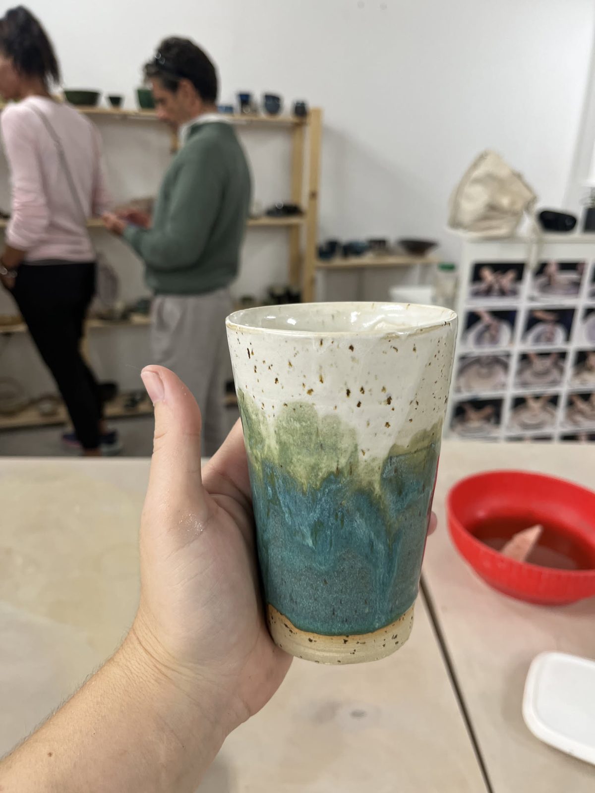 Tall speckled tumbler with a white, green and teal glaze